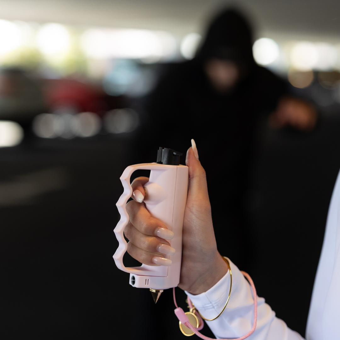 Woman using Safely SOS Sidekick personal safety device in parking garage women's safety tool